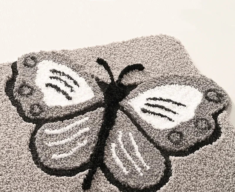Tapis de bain papillon peluche